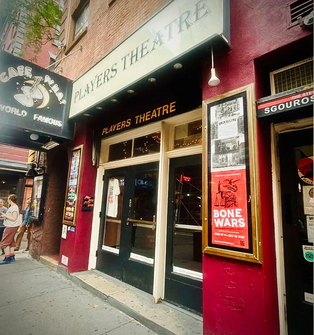 Bone Wars The Musical show poster in front of the Players Theatre in New York